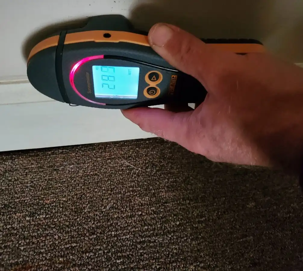 Moisture detection at baseboard during Storm Damage Restoration in Fort Wright